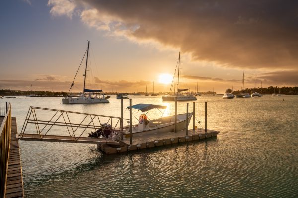 Sunset in Mauritius Grand Baie harbor with boats in foreground